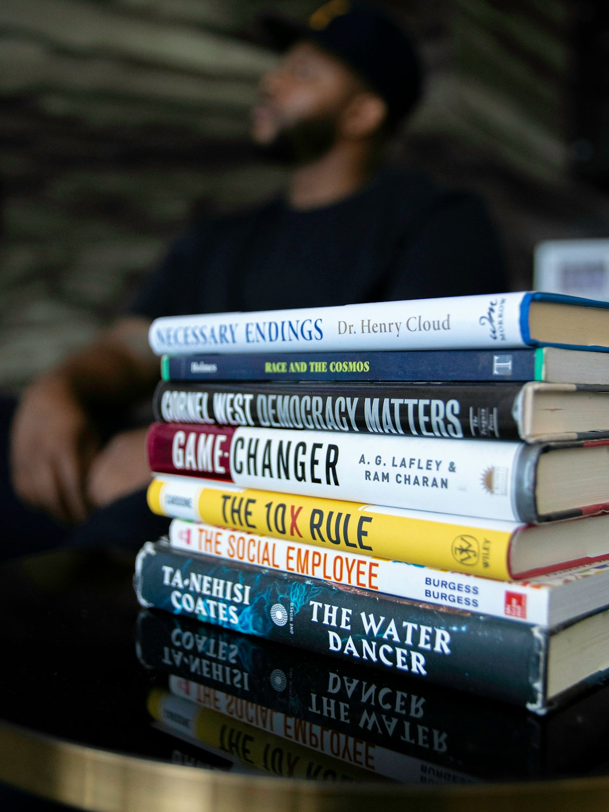 man in black shirt reading books